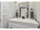 Modern bathroom featuring a white vanity, black hardware, framed mirror, and neutral tile at 1071 Lexington Ct, Largo, FL 33771