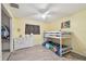 bedroom featuring yellow walls, ceiling fan, dresser, and bunk bed at 1071 Lexington Ct, Largo, FL 33771