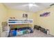 bedroom featuring yellow walls, ceiling fan, bunk bed, and wood-look flooring at 1071 Lexington Ct, Largo, FL 33771