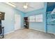 Bedroom with ample space featuring blue walls, wood-look floors, ceiling fan, and closet with shelves at 1071 Lexington Ct, Largo, FL 33771