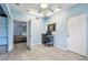 Bedroom with ample space featuring blue walls, wood-look floors, ceiling fan, and closet with shelves at 1071 Lexington Ct, Largo, FL 33771