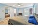 Spacious bedroom with blue walls, fan, wood-look floors, access to bath and closet with mirror doors at 1071 Lexington Ct, Largo, FL 33771