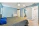 Spacious bedroom featuring blue walls, wood-look floors, ceiling fan, and access to the bathroom at 1071 Lexington Ct, Largo, FL 33771