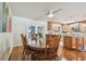 Dining area with hardwood floors, a ceiling fan, a wooden dining table, and a view of the kitchen at 1071 Lexington Ct, Largo, FL 33771