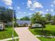 Charming home featuring a well-manicured lawn and inviting brick driveway, exuding curb appeal and warmth at 1071 Lexington Ct, Largo, FL 33771