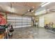 Spacious garage with concrete floor, ceiling fans, storage cabinets, and garage door at 1071 Lexington Ct, Largo, FL 33771