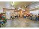 Spacious garage with concrete floor, ceiling fans, storage cabinets, and hanging lights at 1071 Lexington Ct, Largo, FL 33771