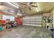 Spacious garage with concrete floor, ceiling fans, storage cabinets, and garage door at 1071 Lexington Ct, Largo, FL 33771