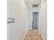 Hallway features tile flooring and access to bedroom and bathroom at 1071 Lexington Ct, Largo, FL 33771