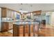 Bright kitchen boasts wood cabinets, granite countertops, stainless steel appliances, and an island with seating at 1071 Lexington Ct, Largo, FL 33771