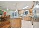 Kitchen with stainless steel appliances, granite countertops, wooden cabinets, dining area, and kitchen island at 1071 Lexington Ct, Largo, FL 33771