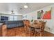 View of dining area and living room featuring a recliner sofa, art, and hardwood floors at 1071 Lexington Ct, Largo, FL 33771