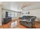 Comfortable living room featuring a large television, sectional seating, and hardwood floors at 1071 Lexington Ct, Largo, FL 33771