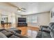 Spacious living room featuring hardwood floors, a ceiling fan, and a comfortable grey reclining sofa at 1071 Lexington Ct, Largo, FL 33771