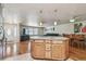 Open concept kitchen, dining, and living space with hardwood floors and granite countertops at 1071 Lexington Ct, Largo, FL 33771