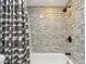 Shower features modern neutral tile, rainfall shower head, and sleek black fixtures at 1071 Lexington Ct, Largo, FL 33771