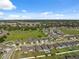 Beautiful aerial view of a neighborhood with well-maintained homes and lush green spaces on a sunny day at 1098 Old Windsor Way, Spring Hill, FL 34609