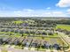 Overhead view of a community showcasing neatly arranged homes, playgrounds and green spaces at 1098 Old Windsor Way, Spring Hill, FL 34609