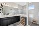 Modern bathroom featuring double sinks, a walk-in shower with glass enclosure, and tiled walls at 1098 Old Windsor Way, Spring Hill, FL 34609