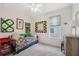 Bright bedroom featuring a window, a ceiling fan, and colorful quilts on the wall at 1098 Old Windsor Way, Spring Hill, FL 34609