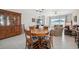 Dining area with wood table set and chairs, seamlessly integrated with the living space at 1098 Old Windsor Way, Spring Hill, FL 34609