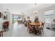 Open-concept dining area with wood furniture and bright natural lighting at 1098 Old Windsor Way, Spring Hill, FL 34609