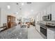Contemporary kitchen featuring a granite island, white cabinets and stainless steel appliances at 1098 Old Windsor Way, Spring Hill, FL 34609