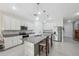 Modern kitchen with stainless steel appliances, granite countertops, and white cabinets at 1098 Old Windsor Way, Spring Hill, FL 34609