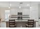 Bright kitchen featuring a large island, stainless steel appliances, and stylish pendant lighting at 1098 Old Windsor Way, Spring Hill, FL 34609
