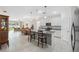 Bright, open kitchen with white cabinetry, granite countertops, and modern stainless steel appliances at 1098 Old Windsor Way, Spring Hill, FL 34609