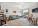 Cozy living room featuring a comfortable sofa, rocking chair, and natural light at 1098 Old Windsor Way, Spring Hill, FL 34609