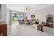 Cozy living room with tiled flooring, sliding glass doors to the patio and comfortable seating at 1098 Old Windsor Way, Spring Hill, FL 34609