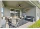 Relaxing covered patio with ceiling fan and comfortable seating area, perfect for outdoor enjoyment at 1098 Old Windsor Way, Spring Hill, FL 34609