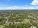 Aerial view of the community showcasing the homes and the surrounding lush green landscape at 11034 Flock Ave, Weeki Wachee, FL 34613