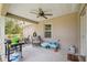 Covered back porch with a ceiling fan, seating area, grill, and view of the backyard at 11034 Flock Ave, Weeki Wachee, FL 34613
