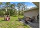 Spacious backyard with a playhouse and slide and a patio set for outdoor relaxation at 11034 Flock Ave, Weeki Wachee, FL 34613