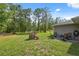 The backyard shows a playhouse with a slide and a patio with a table and chairs near the house at 11034 Flock Ave, Weeki Wachee, FL 34613