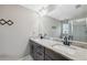 Bathroom featuring double sink vanity with granite countertop, modern faucets, and a glass door shower at 11034 Flock Ave, Weeki Wachee, FL 34613