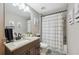 Bathroom with a shower-tub combo, updated fixtures, and neutral decor creating a clean and modern space at 11034 Flock Ave, Weeki Wachee, FL 34613