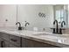 Modern bathroom featuring double sink vanity with granite counters and contemporary faucet hardware at 11034 Flock Ave, Weeki Wachee, FL 34613
