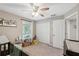 Bedroom showcasing neutral walls, ceiling fan, window, closet, and decor creating a warm space at 11034 Flock Ave, Weeki Wachee, FL 34613