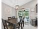 Cozy dining area with modern light fixture and sliding glass doors to the outdoor space at 11034 Flock Ave, Weeki Wachee, FL 34613