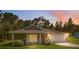Charming single-story home featuring a two-car garage, well-manicured lawn, and a cozy front porch at 11034 Flock Ave, Weeki Wachee, FL 34613