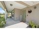 Inviting covered front porch with stylish welcome decor, potted plants, and a seating area at 11034 Flock Ave, Weeki Wachee, FL 34613