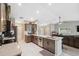 Open kitchen featuring stone counters, tiled floor, stainless appliances and easy access to the living room at 11034 Flock Ave, Weeki Wachee, FL 34613
