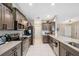 Modern kitchen featuring stone counters, stainless steel appliances and easy access to main entry at 11034 Flock Ave, Weeki Wachee, FL 34613