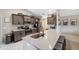 Stylish kitchen features stone counters, stainless steel appliances and wraparound bar seating at 11034 Flock Ave, Weeki Wachee, FL 34613