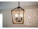 Close-up of the dining room's stylish, four-bulb light fixture at 11034 Flock Ave, Weeki Wachee, FL 34613
