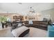 Expansive living room seamlessly connects to the dining area and kitchen, perfect for entertaining at 11034 Flock Ave, Weeki Wachee, FL 34613