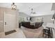 Comfortable living room features a ceiling fan, vaulted ceiling and large windows at 11034 Flock Ave, Weeki Wachee, FL 34613